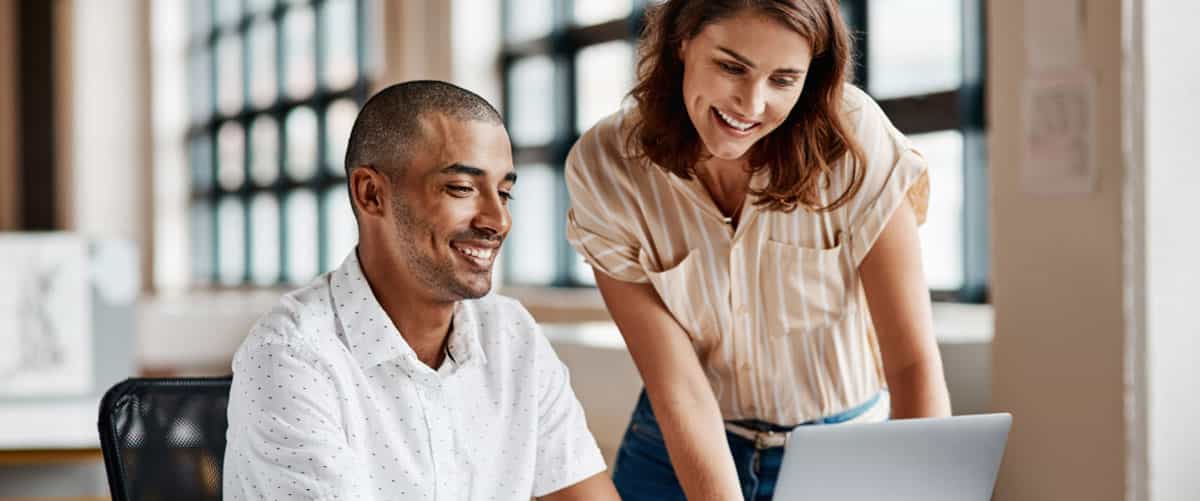 man and woman looking at a screen